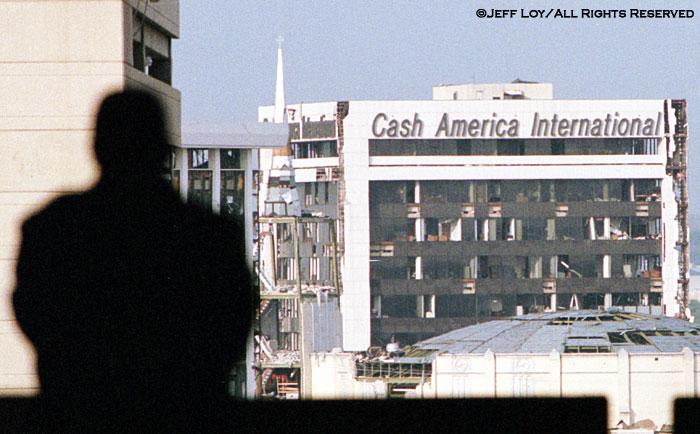 A RadioShack Corporation security guard looks toward buildings that suffered tornado damage. The storm killed two people and caused millions of dollars in damage to the downtown Fort Worth area.