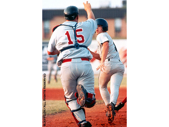 Detroit High School's Joey McCoin looks back at Prarieland High School catcher David Ford while caught in a run down between first and second base.